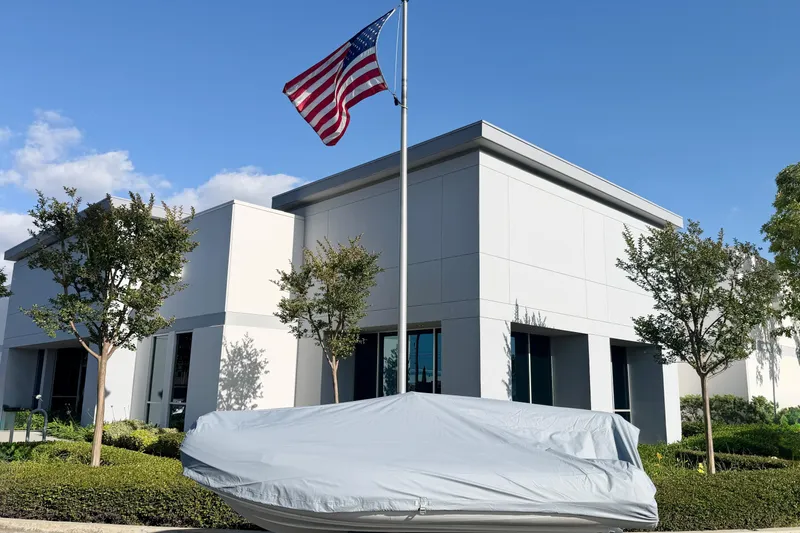 Slide: The Image of Covered 2019 Brig Eagle 340 boat near modern building with American flag. - 21