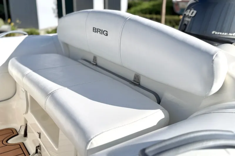 Slide: The Image of 2019 Brig Eagle 340 boat with white cushioned seating and visible outboard motor. - 4
