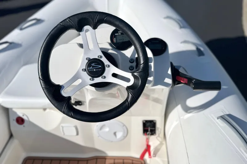 Slide: The Image of Steering wheel and controls of 2019 Brig Eagle 340 boat, featuring sleek design. - 6