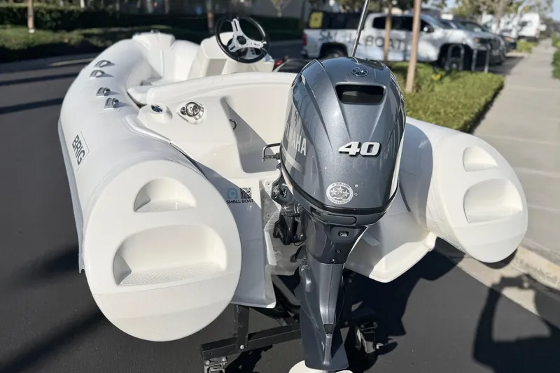 Slide: The Image of 2019 Brig Eagle 340 inflatable boat with Yamaha 40 outboard motor, parked outdoors. - 8
