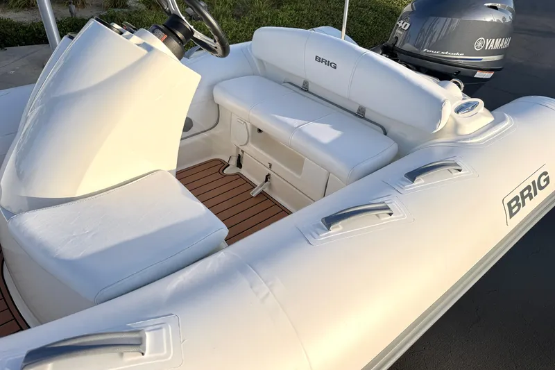 Slide: The Image of 2019 Brig Eagle 340 inflatable boat with Yamaha engine, featuring white seating and teak flooring. - 9