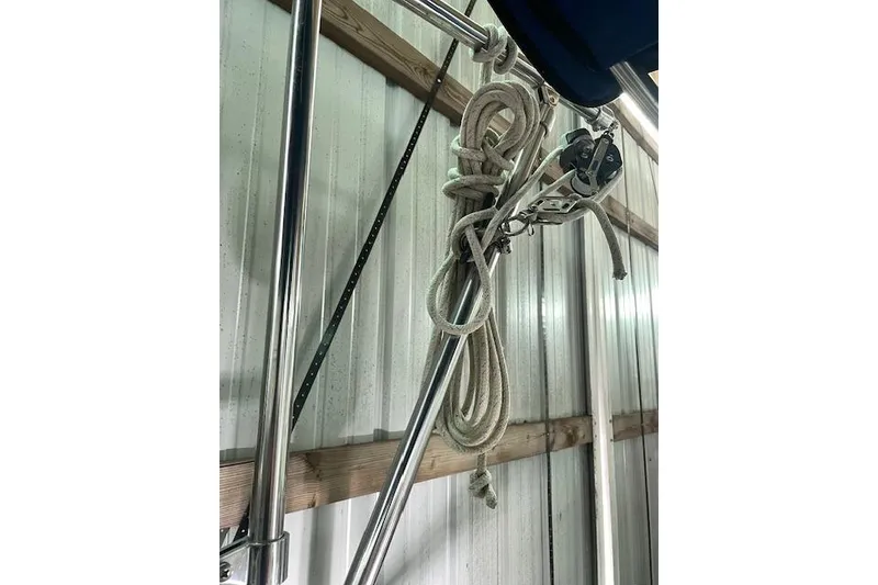 Slide: The Image of Coiled rope and pulley system on 1984 Endeavour 35 sailboat, stored indoors. - 11