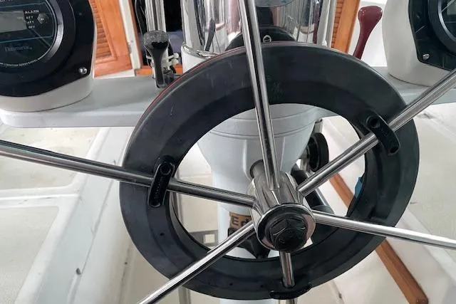 Slide: The Image of Steering wheel of a 1984 Endeavour 35 sailboat, showcasing nautical instrumentation. - 13