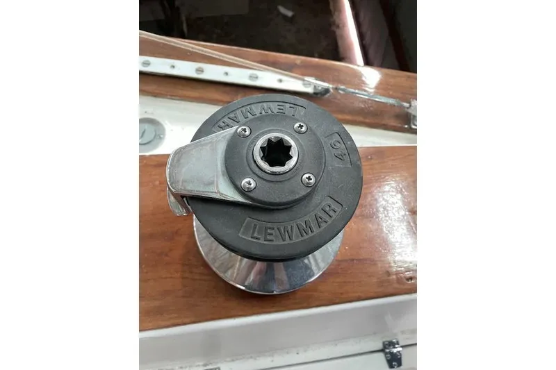 Slide: The Image of Lewmar winch on 1984 Endeavour 35 sailboat, mounted on polished wooden surface. - 16