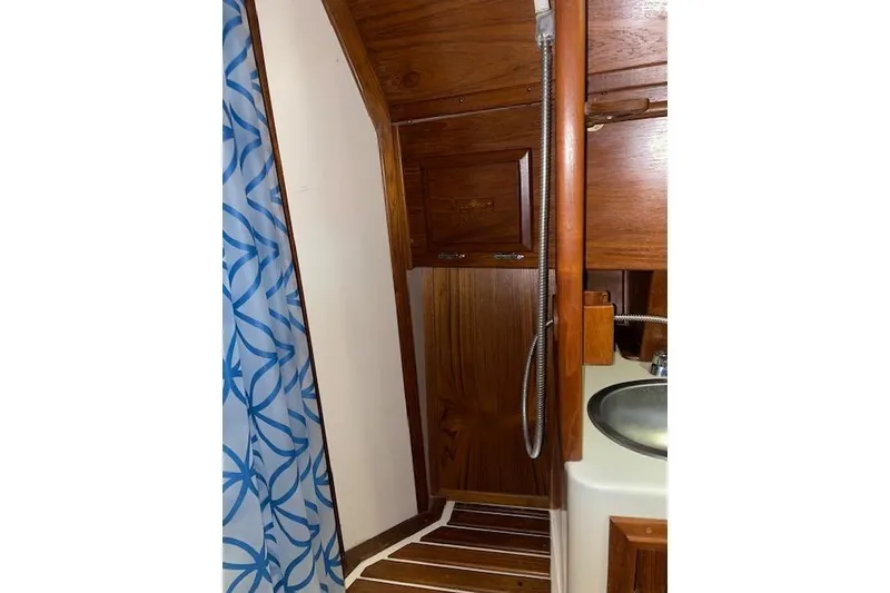 Slide: The Image of 1984 Endeavour 35 yacht interior with wooden cabinetry and shower area. - 19