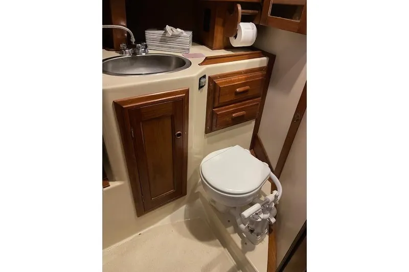Slide: The Image of Compact bathroom in 1984 Endeavour 35 yacht with sink, toilet, and wooden cabinetry. - 22