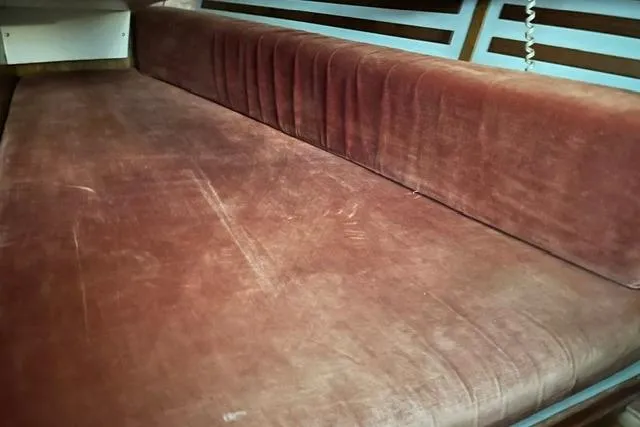 Slide: The Image of Vintage 1984 Endeavour 35 sailboat interior with red velvet seating. - 23