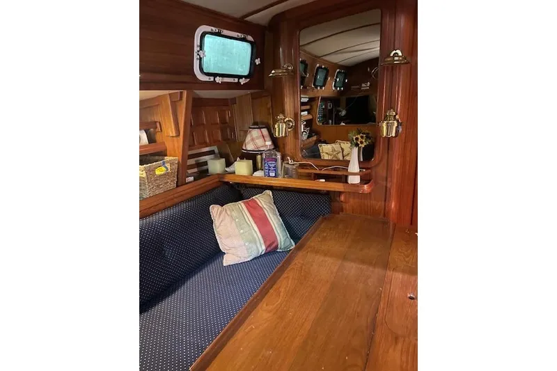 Slide: The Image of Cozy interior of 1984 Endeavour 35 sailboat with wooden furnishings and nautical decor. - 29