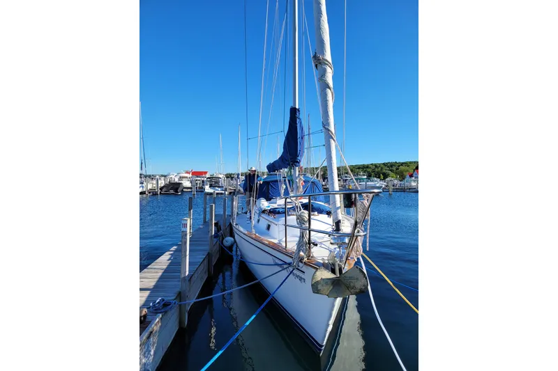 Slide: The Image of 1984 Endeavour 35 sailboat docked at a marina under clear blue skies. - 4