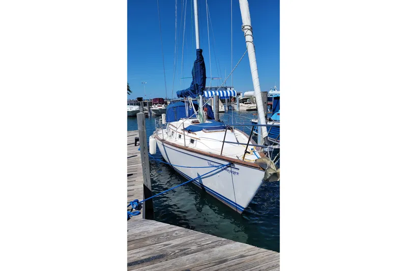 Slide: The Image of 1984 Endeavour 35 sailboat docked at marina, featuring blue and white accents. - 6