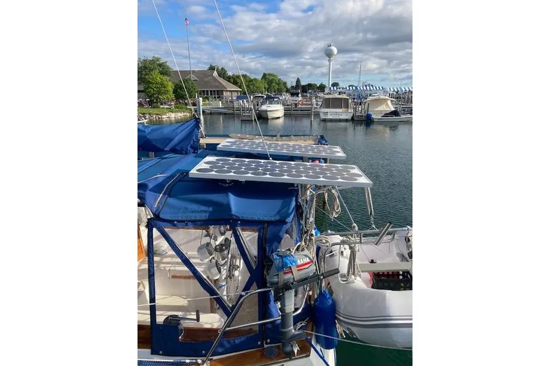 Slide: The Image of Sailboat Endeavour 35 (1984) with solar panels docked at a marina. - 8