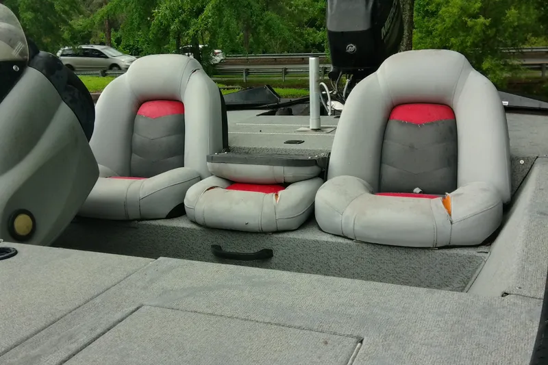 Slide: The Image of 2016 Tracker Pro Team 175 TXW boat interior with gray and red seats. - 3