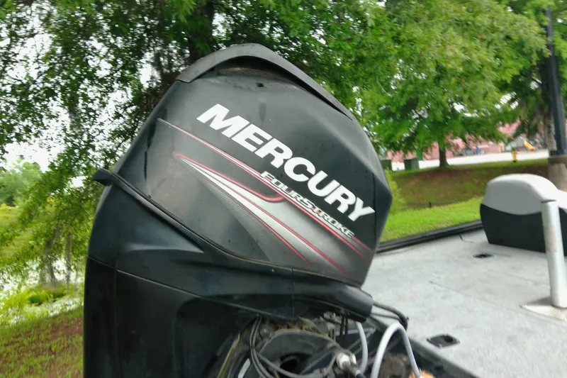 Slide: The Image of 2016 Tracker Pro Team 175 TXW with Mercury outboard motor in a lush setting. - 6