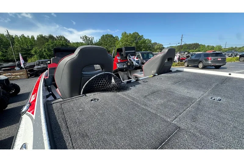 Slide: The Image of 2023 Nitro Z20 Pro fishing boat interior with seats and steering wheel, parked outdoors. - 11