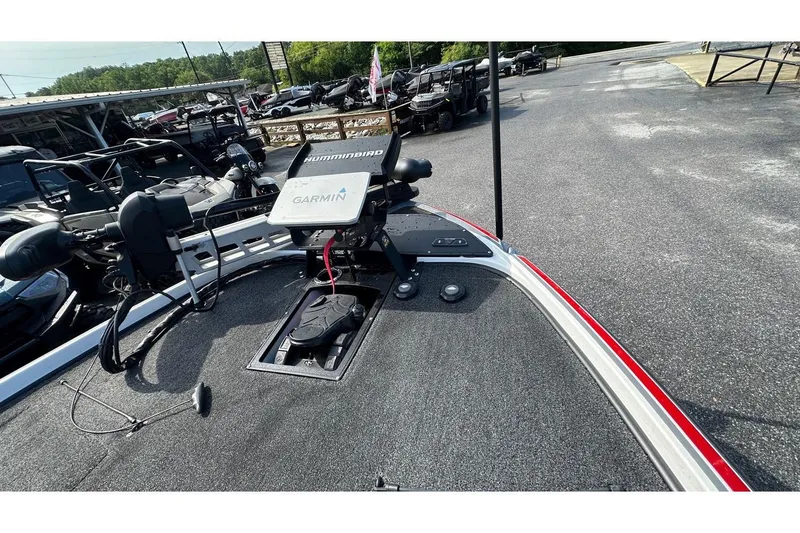 Slide: The Image of 2023 Nitro Z20 Pro boat deck with Garmin and Humminbird electronics, parked outdoors. - 2