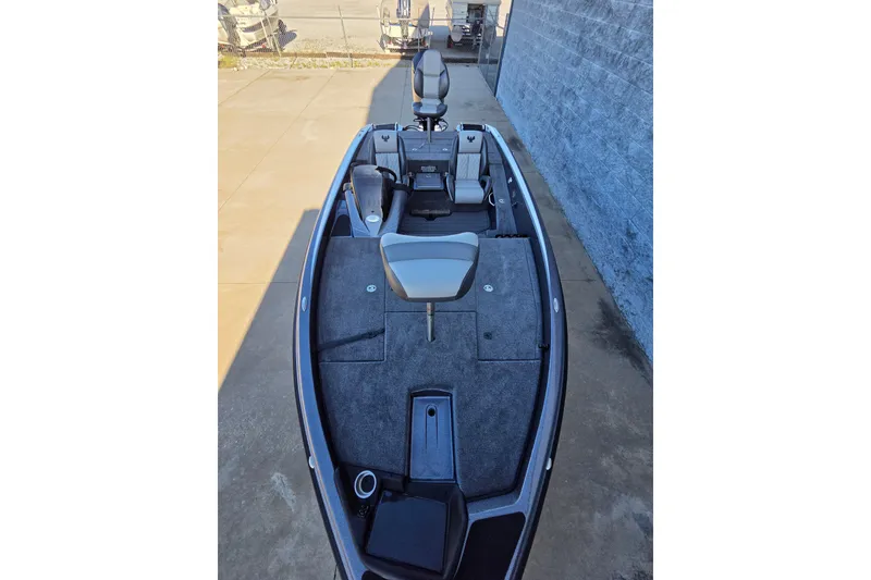 Slide: The Image of 2026 Phoenix 818 Pro fishing boat with spacious deck and seating, parked outdoors. - 10