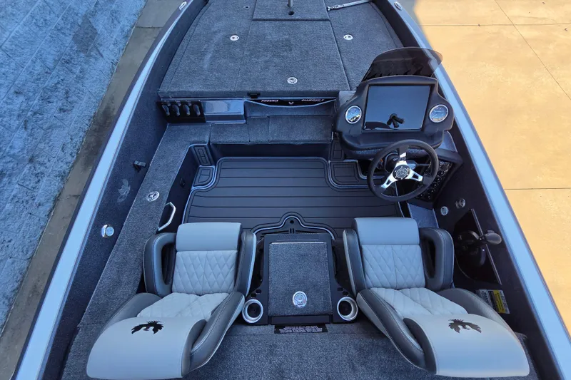 Slide: The Image of 2026 Phoenix 818 Pro boat interior with dual seats, steering console, and carpeted flooring. - 8