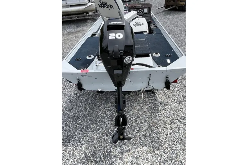 Slide: The Image of 1990 Sea Nymph TX175 Tour Pro boat with Mercury 20 outboard motor on gravel surface. - 2