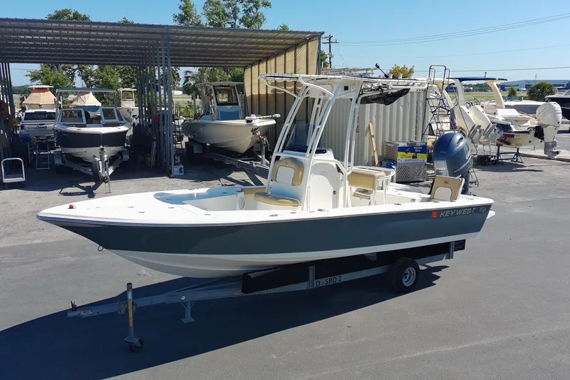 The Image of 2015 Key West 210 Bay Reef boat on trailer in marina lot. - 0