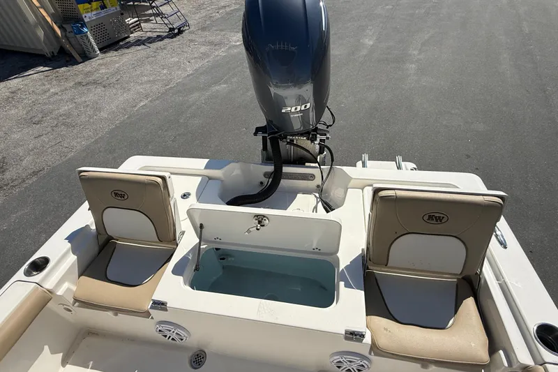 Slide: The Image of 2015 Key West 210 Bay Reef boat with dual seats and outboard motor. - 10