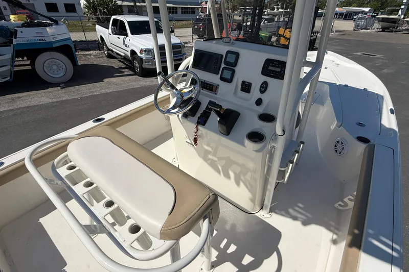 Slide: The Image of 2015 Key West 210 Bay Reef boat interior with steering console and seating. - 11