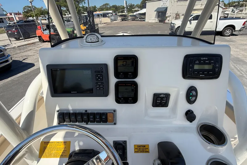 Slide: The Image of Control panel of a 2015 Key West 210 Bay Reef boat with navigation instruments. - 12
