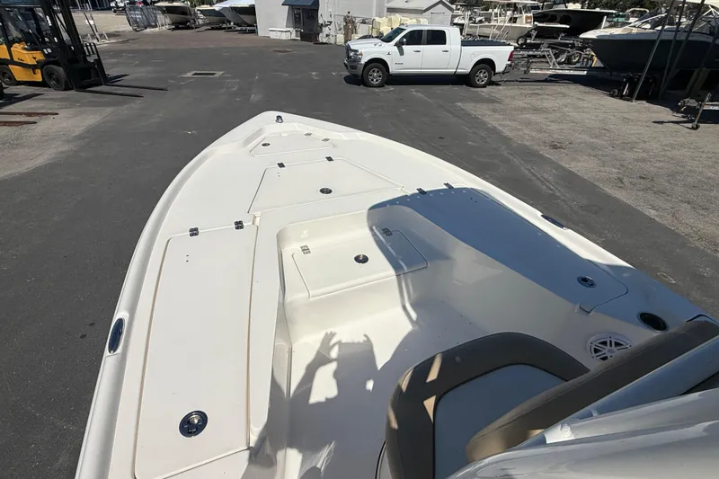 Slide: The Image of 2015 Key West 210 Bay Reef boat on display in a marina parking lot. - 16