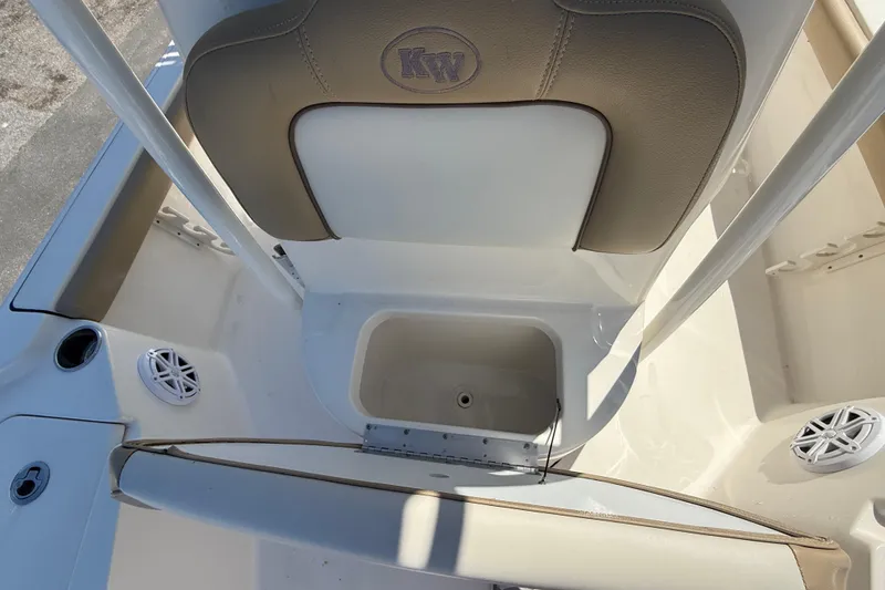 Slide: The Image of 2015 Key West 210 Bay Reef boat interior with seating and storage compartment. - 17