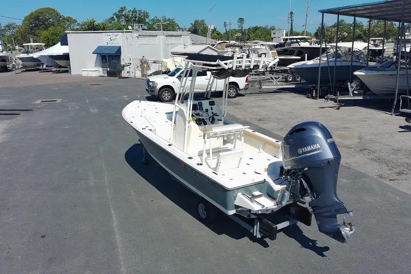 Slide: The Image of 2015 Key West 210 Bay Reef boat with Yamaha engine in a marina setting. - 2