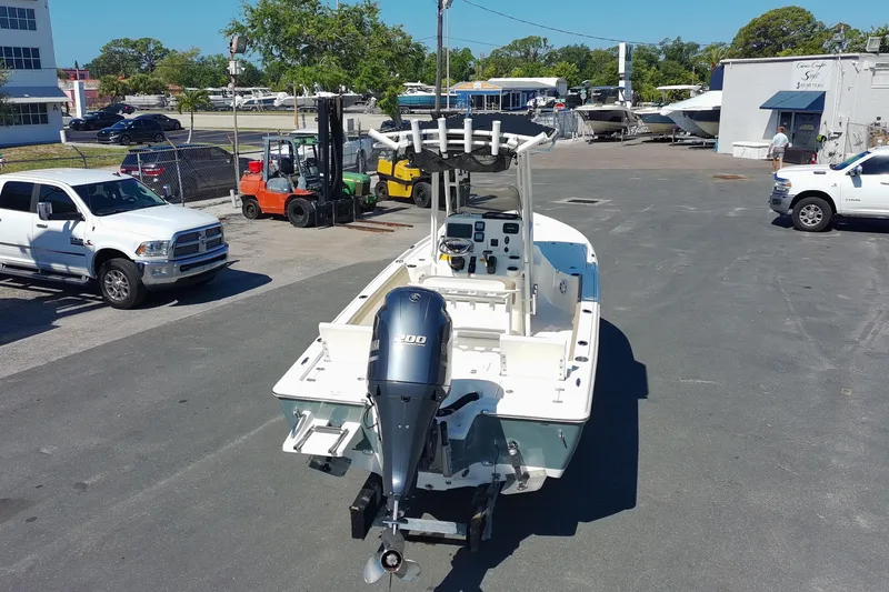 Slide: The Image of 2015 Key West 210 Bay Reef boat with outboard motor in a marina parking lot. - 3