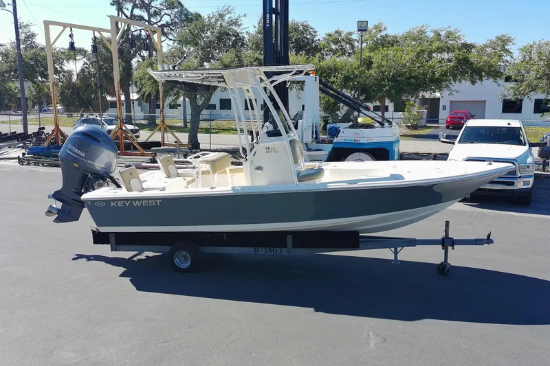 Slide: The Image of 2015 Key West 210 Bay Reef boat on trailer, featuring Yamaha outboard motor. - 4
