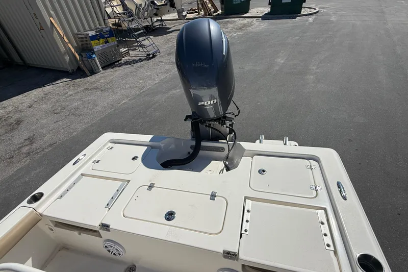 Slide: The Image of 2015 Key West 210 Bay Reef boat with 200 HP outboard motor, docked outdoors. - 9