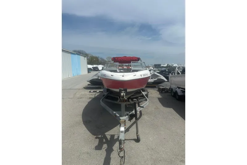 The Image of 2008 Yamaha Boats SX230 on trailer, parked outdoors under clear sky. - 1