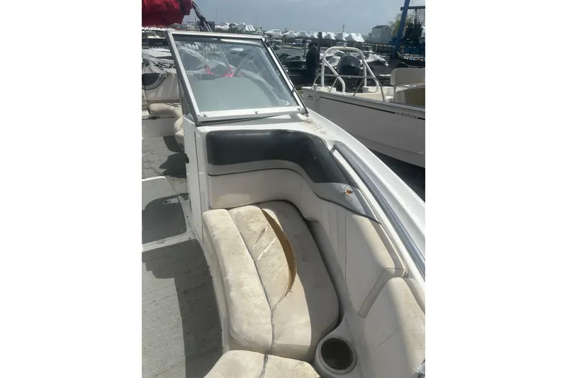Slide: The Image of 2008 Yamaha Boats SX230 interior with worn seating and open deck view. - 16
