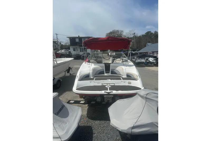 Slide: The Image of 2008 Yamaha Boats SX230 with red canopy, parked outdoors on gravel. - 7