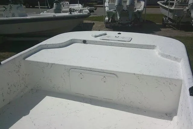 Slide: The Image of 2010 Key West 197 Skiff boat interior with white deck and storage compartment. - 10