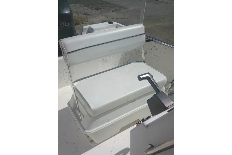 Slide: The Image of 2010 Key West 197 Skiff boat interior with white seating and control lever. - 15