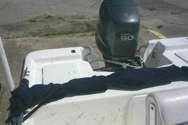 Slide: The Image of 2010 Key West 197 Skiff boat with Yamaha 90 outboard motor, docked on concrete surface. - 16