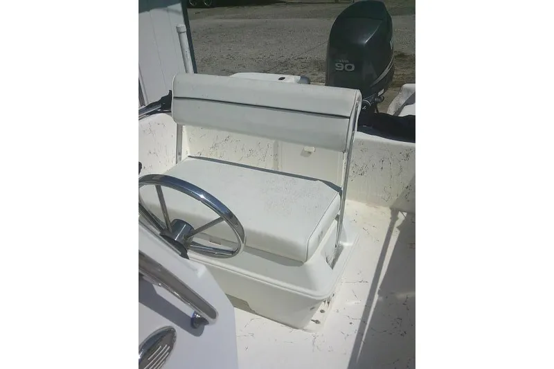 Slide: The Image of 2010 Key West 197 Skiff boat interior with steering wheel and Yamaha 90 engine. - 19