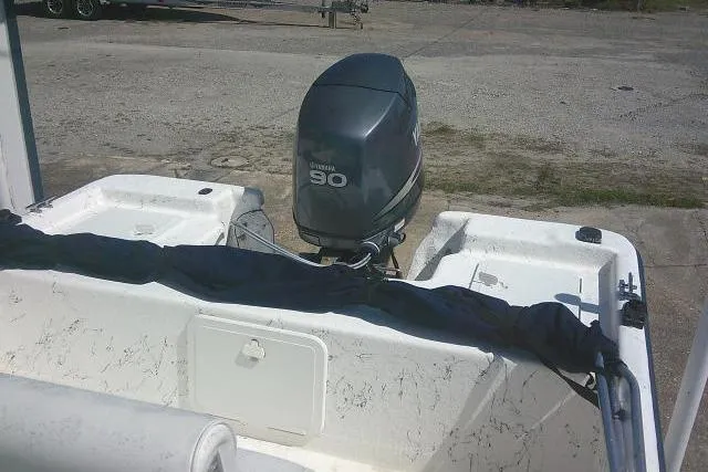 Slide: The Image of 2010 Key West 197 Skiff with Yamaha 90 outboard motor, parked on concrete. - 20