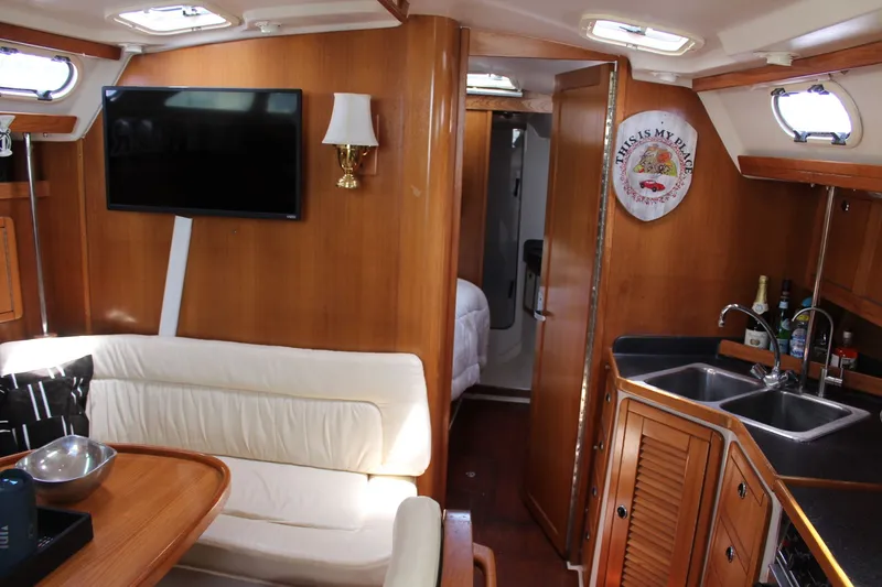 Slide: The Image of Interior of a 2004 Catalina 42 MkII yacht with cozy living area. - 34