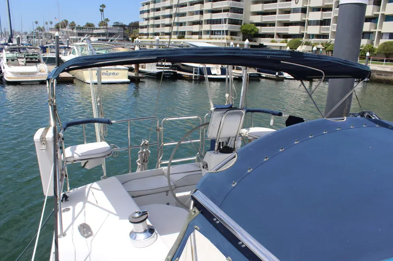 Slide: The Image of 2004 Catalina 42 MkII sailboat docked, featuring blue canopy. - 6