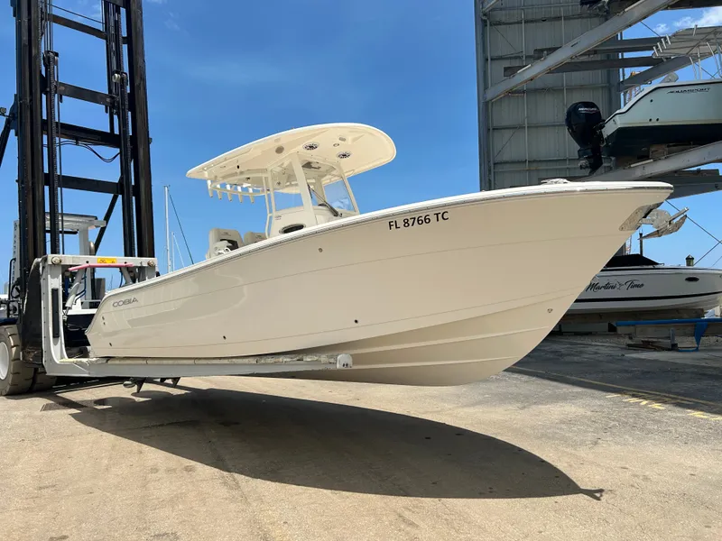 The Image of 2022 Cobia 262 Center Console boat on a forklift. - 0