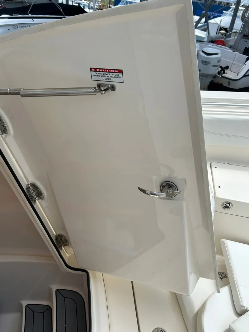 Slide: The Image of Open door on a 2022 Cobia 262 Center Console boat. - 18
