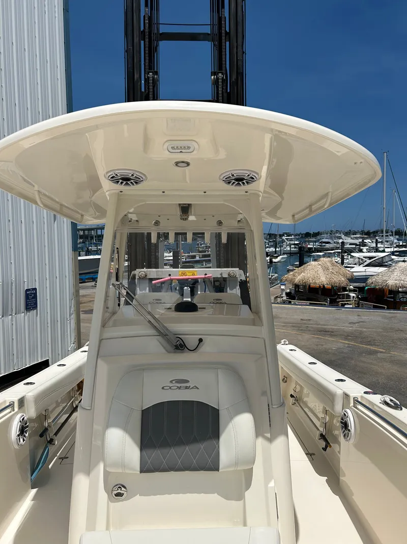 Slide: The Image of 2022 Cobia 262 Center Console boat at the marina. - 19