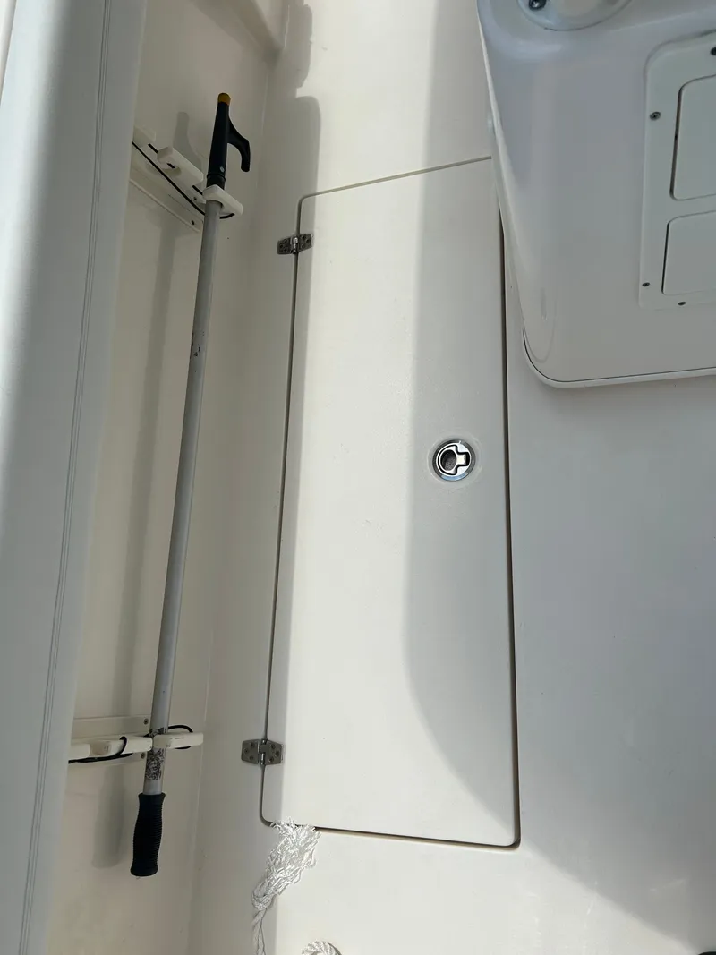 Slide: The Image of Interior of a 2022 Cobia 262 Center Console with storage compartment. - 33