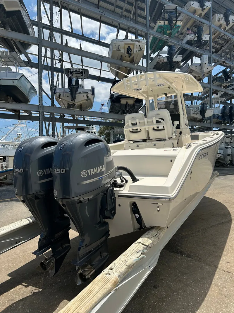 Slide: The Image of 2022 Cobia 262 Center Console with Yamaha engines in marina. - 44