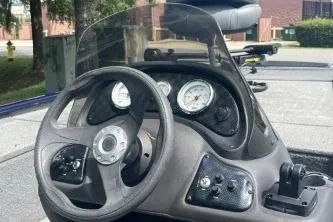 Slide: The Image of 2019 Tracker Pro 170 boat dashboard with steering wheel and gauges. - 10
