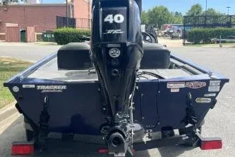 Slide: The Image of 2019 Tracker Pro 170 boat with a 40 HP motor, parked outdoors. - 4