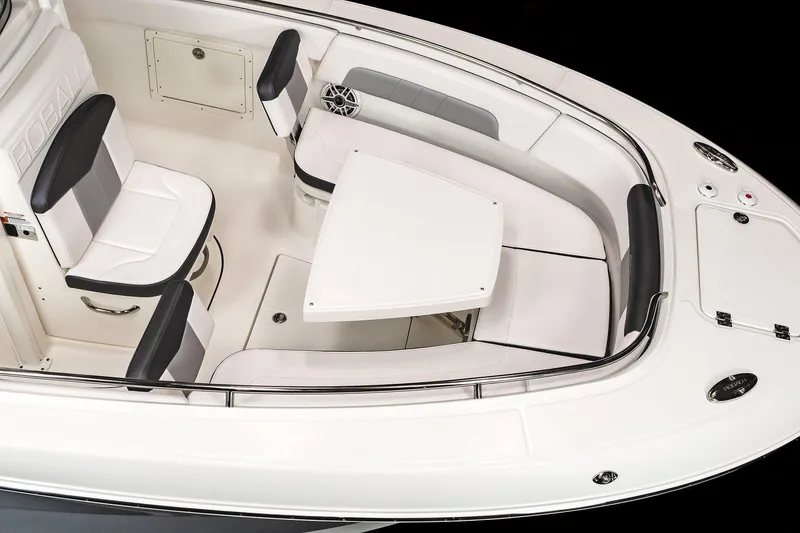 Slide: The Image of Manufacturer Provided Image: 2023 Robalo R242 Explorer boat interior with seating and table. - 12